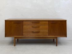 A mid-century Danish style teak sideboard having a rectangular top over an arrangement of three