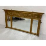 A 20th century Regency style gilt overmantel triptych mirror having a moulded breakfront cornice