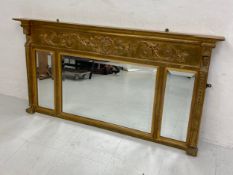 A 20th century Regency style gilt overmantel triptych mirror having a moulded breakfront cornice