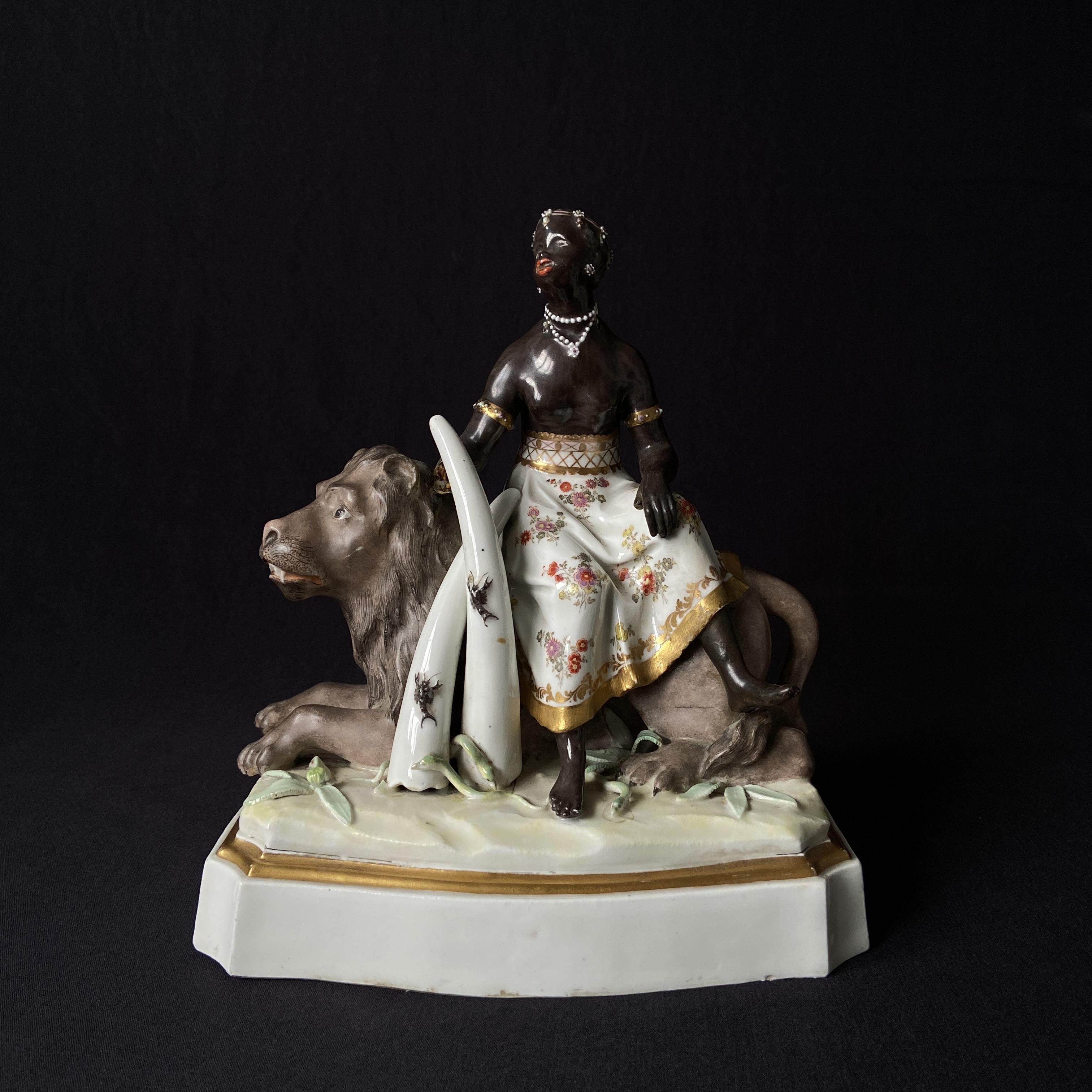 An 18th century hand painted European porcelain allegory of Africa depicting a blackamoor figure on