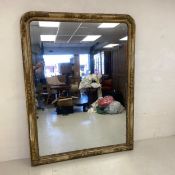 A large 19th century overmantle or floor mirror with its original plate in a gesso and gilt frame.