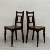 A pair of 19th century oak hall or side chairs each having a square back with openwork splat over