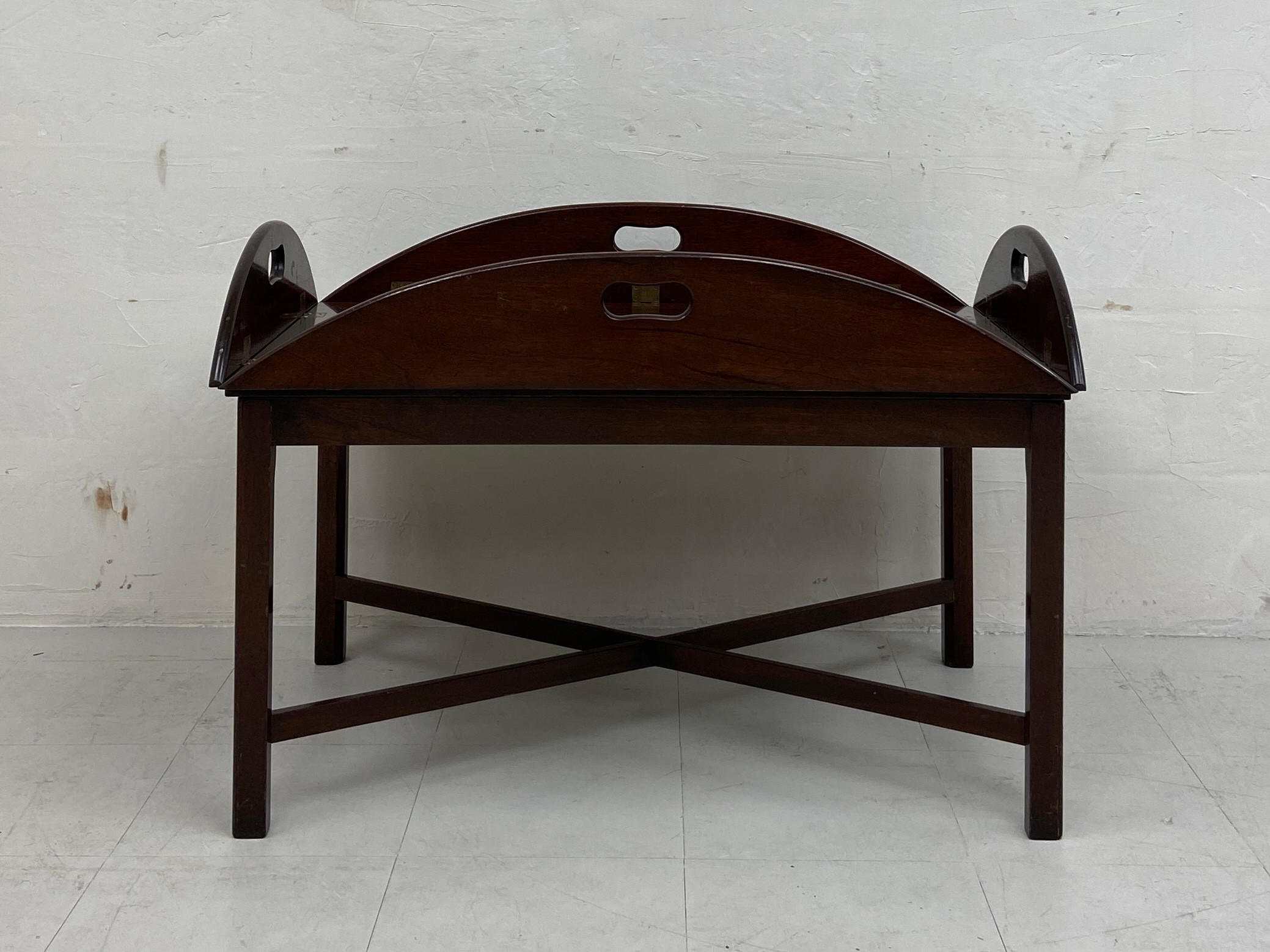 A large 19th century mahogany butler's tray table in two parts having an oval top with hinged