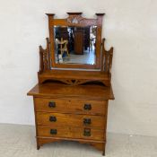 A C.1900 oak Arts & Crafts dressing table having a shaped openwork superstructure with a square