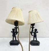 A pair of small 19th century French figural table or side lamps each having a bronze putto stem with