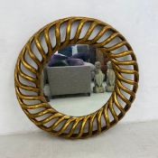 A large wall mirror in carved openwork giltwood frame by Harrison & Gil. Dia.126cm
