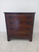 A 19th century Georgian style cupboard having a satinwood inlaid top over four long graduating dummy