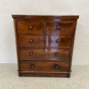 A 19th century mahogany chest of two short over three long cockbeaded drawers with turned handles