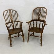 Two 19th century elm Windsor chairs each having a curved and spindled back with a shaped openwork