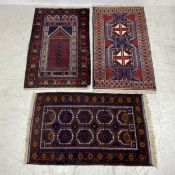 An Afghan style Mihrab along with two Caucasian rugs. 155x84cm (largest)