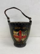 A late 19th century leather fire bucket hand painted with the St. George's flag in a laurel wreath