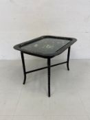 A Regency style lacquered papier-mache Chinoiserie table having a hand painted floral tray top