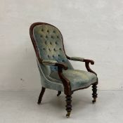 A 19th century mahogany open library armchair having a curved top-rail and deep buttoned back with
