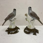 A pair of 19th century hand painted French porcelain figural birds on scrolling Rococo style