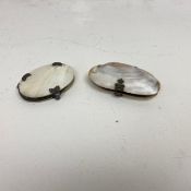 A Georgian white metal mounted mother-of-pearl folding magnifying glass along with a similar
