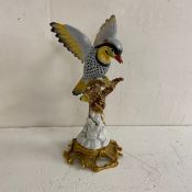 A 19th century French Sevres style bird on a branch raised on gilt Rococo scrolling base. H.31cm