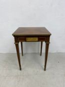 An Empire style card table with swivel envelope top action and ormolu mounts raised on square