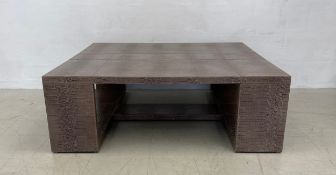 A contemporary coffee table in faux snakeskin. 41x120x120cm
