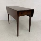 A Georgian mahogany Pembroke table having a square top with two drop leaves over a single frieze
