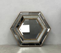 A contemporary Venetian style wall mirror in bevelled glass cushion frame. 83x83cm