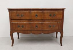A 19th century French Provincial fruitwood commode chest the shaped top above two long drawers on
