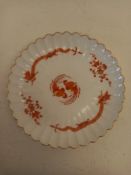 An early 20th century Meissen 'Red Dragon' pattern scalloped porcelain plate with gilt trim and
