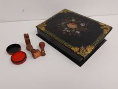 A Victorian papier mache writing slope with hand painted flowerhead and gilt decoration along with a
