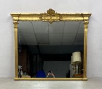 A 19th century style giltwood and gesso overmantel mirror with foliate scrolling cresting above