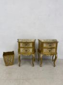 A pair of vintage Florentine gilt and painted three drawer bedside cabinets with all-over