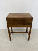 A mid century teak sewing box with fitted interior on stand. 54x41x27cm
