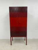 A contemporary Luisa Peixoto painted and lacquered cabinet on stand with maker's label. 163x61x40cm.