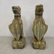 A pair of composite stone mythical beasts, standing guard and holding shields, drip glazed with