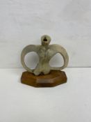 A glazed figure, mid century modernist style on hardwood base. 27x26cm
