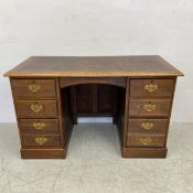 A late 19th century twin pedestal oak desk having a rectangular thumb-moulded top over an