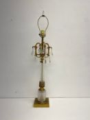 A cut glass and brass mounted table lamp with crystal drops. H.89cm.
