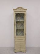 A late 19th century French Provincial narrow display cabinet with glazed door enclosing Toile