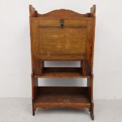A C.1900 Arts and Crafts oak students bureau or escritoire writing desk with fall front revealing
