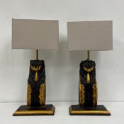 A pair of carved painted and gilt table lamps of neoclassical corbel form with square shades