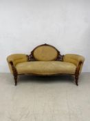 A mid 19th century carved walnut sofa in flowerhead upholstery on turned tapering reeded supports.