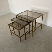 A nest of three vintage Hollywood Regency style tables each having a square smoked glass top set