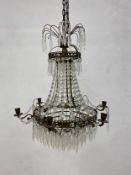 An early 20th century French metal framed chandelier with crystal drops, fitted for electricity with