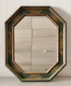 A Continental style wall mirror in hand decorated octagonal frame. 84x69cm
