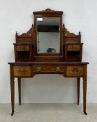 A 19th century rosewood dressing table having a shaped superstructure with swing mirror over a