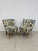 A pair of contemporary retro styled salon chairs on tapering beech supports. H.78cm