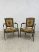 A pair of early 20th century Louis XVI style armchairs with painted frames and original tapestry