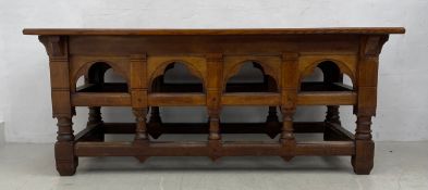 A late 19th century Gothic revival oak altar table with carved arched frieze on turned stretchered