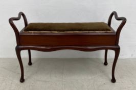 A late 19th century mahogany duet stool with hinged lid revealing sheet music compartment on