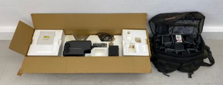 Four Praktica cameras with zoom lenses in a carrying case and a boxed color system enlarger.