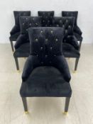 A set of six contemporary black velvet and gilt button back dining chairs each having an