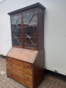 A Georgian mahogany bureau bookcase in two sections with astragal glazed bookcase section above fall
